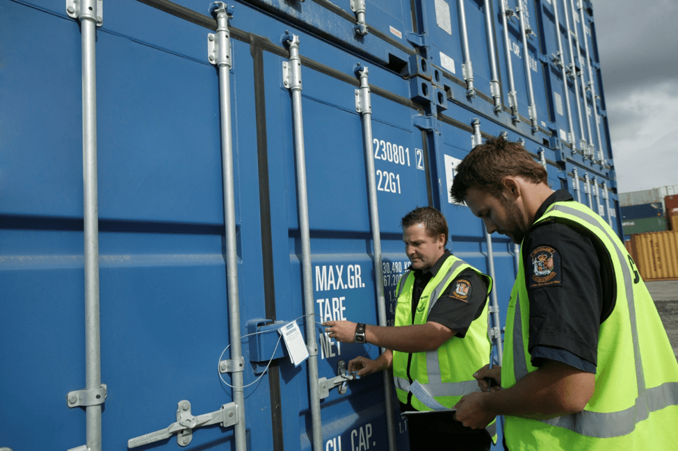 Featured image showing two customs inspectors verifying imports.