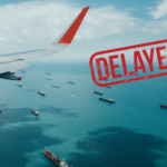 Featured image showing an jet airliner wing flying over several cargo ships