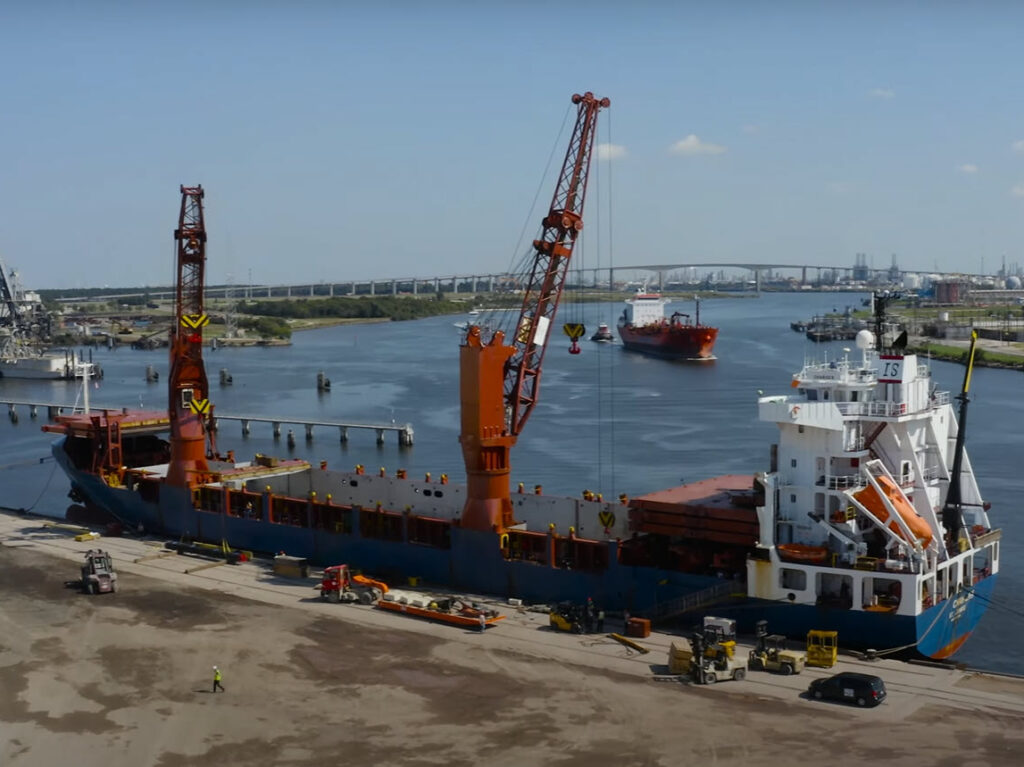 Featured image showing the UTC Overseas logistics crew use a heavy-lift vessel at Port of Houston to load cranes for transport.