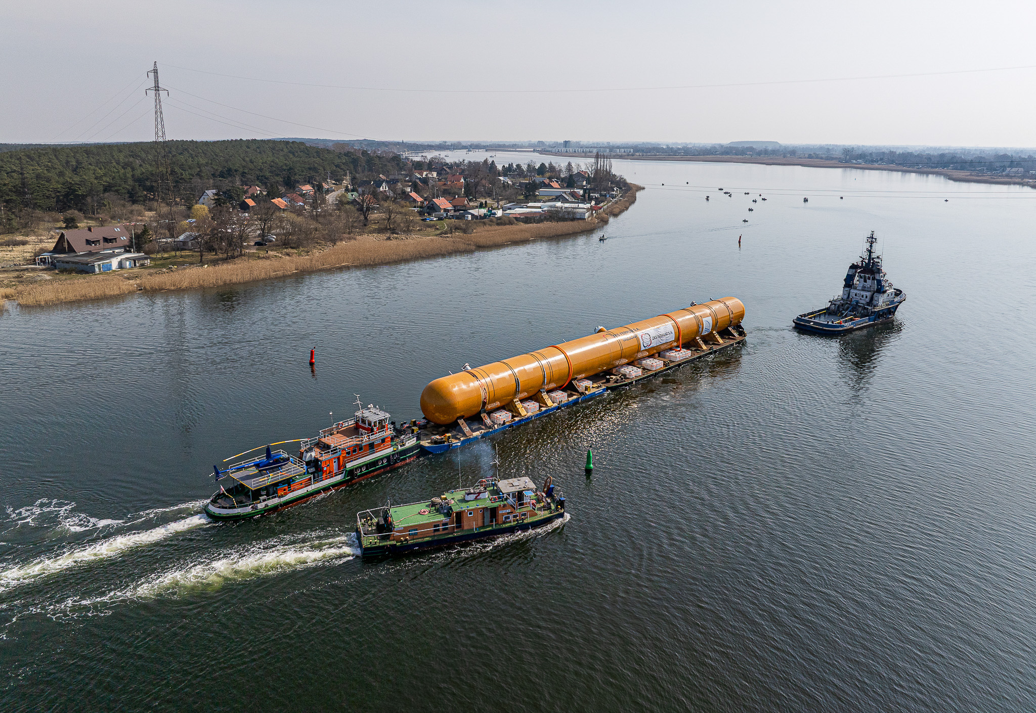 Oversized LPG storage tanks transported by barge along the Vistula River during low water conditions
